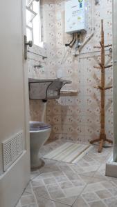 a bathroom with a toilet and a sink at Copacabana aconchegante in Rio de Janeiro