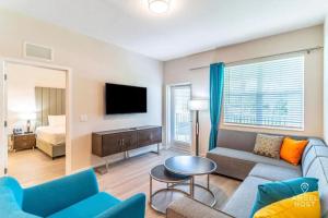 a living room with a couch and a tv and a bed at Apartment at Vista Cay Resort in Orlando