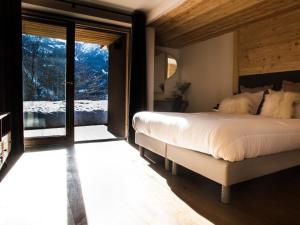 a bedroom with a large bed and a large window at Chalet La Salle-les-Alpes, 6 pièces, 12 personnes - FR-1-762-18 in La Salle-les-Alpes