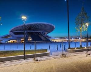 a building with lights in front of a body of water at Hotel Le Terminus in Mons