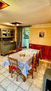 a kitchen with a table and chairs in a room at Maison Le Barbier 10pers Le Mont Dore in Le Mont-Dore