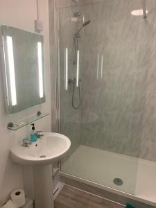 a white bathroom with a shower and a sink at InTown - 60 second walk 2 Minster! in York