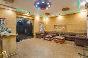 a living room with couches and a table in a room at Heritage Juma Resort with swimming pool in Jaisalmer