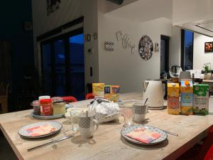 uma mesa de madeira com pratos de comida em Chez Isa em Faymonville