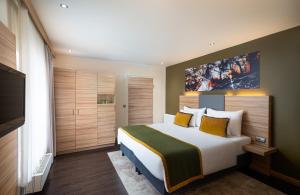 a hotel room with a bed and a television at Leonardo Boutique Hotel Salzburg Gablerbräu in Salzburg