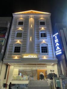 a white building with stairs in front of itaza at Hotel IRAA in Kākināda