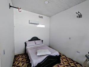 a small room with a bed in the corner at SAN SENDERISMO ROOM in Mariquita