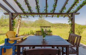 a table and chairs on a patio with a pergola at House Jasenak 