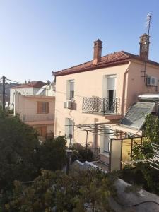 a large white building with a balcony at THALIA'S GARDEN in Mytilene