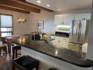a kitchen with a counter top and a refrigerator at Rustic-Contemporary 3Br With Great Views Condo in Crested Butte