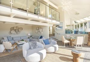 a living room with a blue couch and chairs at 3911 Point Lobos View home in Carmel
