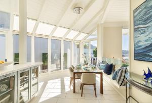 a dining room with a table and some windows at 3911 Point Lobos View home in Carmel
