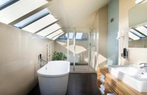 a bathroom with a toilet and a sink at Leonardo Boutique Hotel Salzburg Gablerbräu in Salzburg