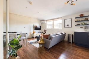 a living room with a couch and a table at The Marylebone Escape - Lovely 1BDR Flat in London