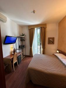 Postel nebo postele na pokoji v ubytování Hotel Aspromonte