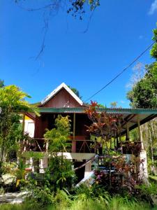a house in the middle of a garden at Delima Cottage, Ngurbloat Beach in Ngurblut