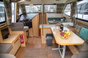 a kitchen with a bowl of fruit on a table at Caley Cruisers in Inverness