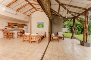 an open kitchen and dining room with a table and chairs at Two Bedroom Villa - Higueron in Islita