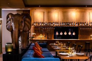 an elephant standing behind a couch in a restaurant at Wyndham Grand Algarve Quinta do Lago in Quinta do Lago