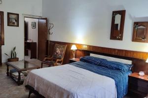 a bedroom with a bed with a blue comforter at Tierra del sol Apart in La Banda
