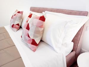 a bed with two pillows on it at Appartamento con Terrazza Fronte Mare in Riccione