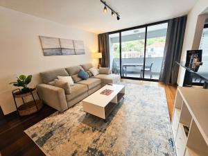 ein Wohnzimmer mit Couch und Tisch in der Unterkunft Machico Oasis - Mountainview in Machico