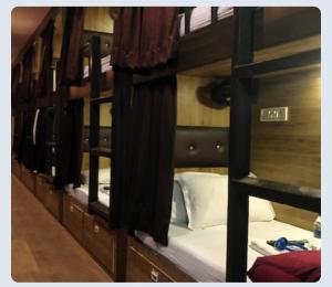 a row of bunk beds in a room at Hilal dormitory in Mumbai