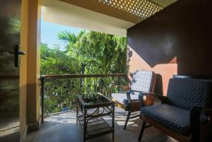 a balcony with two chairs and a table on a porch at Riverview Guest House in Guwahati