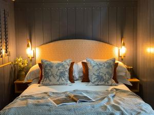 a bedroom with a bed with a book on it at Burley Manor in Burley