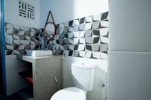a bathroom with a white toilet and a sink at Barriga Da Lua Flats in Jericoacoara +80 photos