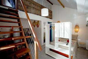 a staircase in a room with white walls at Barriga Da Lua Flats in Jericoacoara