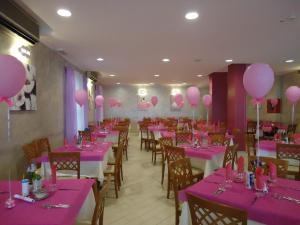 a dining room with pink tables and balloons on the walls at Hotel Mont Blanc in Bellaria-Igea Marina