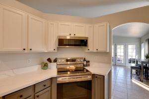 a kitchen with white cabinets and a stove top oven at Golf Course View and Pool Serene Glendale Home in Peoria