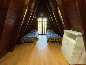 a room with two beds in the middle of a room at Cabañas abuelo pepe in Necochea