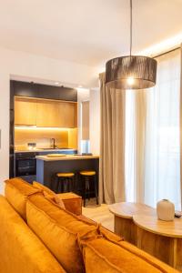 ein Wohnzimmer mit einem Sofa und einer Küche in der Unterkunft Nostos - Luxury Apartment in Agrinio in Agrinio