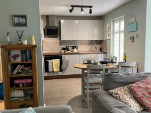 a living room with a couch and a table in a kitchen at Frankie's Holiday Lodge in Gunnislake