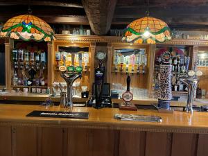 a bar with a counter with many bottles of alcohol at Samuel Pepys in Harwich