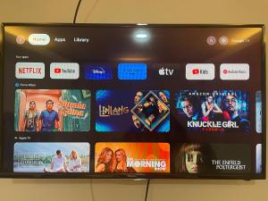 a television screen with many different movies on it at Namal Apartelle - Free Scooter & GYM access in El Nido