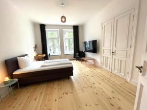 a bedroom with a bed and a television in it at Park Lane Business-Apartment in Hamburg