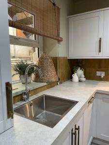 a kitchen counter with a sink and a window at Stylish studio suite in the heart of Brighton in Brighton & Hove