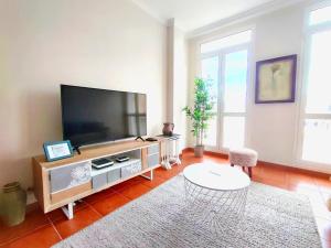 a living room with a large flat screen tv at Duodecima in Las Palmas de Gran Canaria