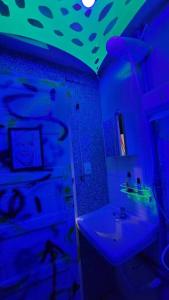 uma casa de banho com um tecto azul e verde e um lavatório. em Um Bar para chamar de SEU! em São Paulo