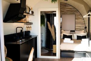 a bedroom with a bed and a sink and a mirror at Glamping Maracujá - Oasis Paradise in Ribeira Brava