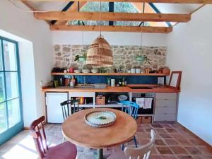 a kitchen with a table and chairs in a room at ZebRegény Vendégház in Zebegény