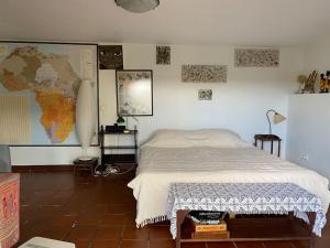 a bedroom with a bed and a map on the wall at Caboz Inn in Horta