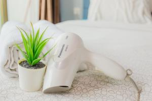 a hair dryer sitting on a table next to a plant at -Lake View- Mount Austin IKEA Toppen 5 mins - B113 in Johor Bahru