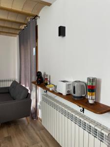 a living room with a couch and a table at Casa de les Escoles, Espinalbet - ALBERGA in Castellar del Riu