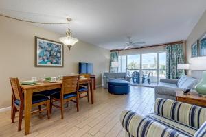 a dining room and living room with a table and chairs at The Resort on Cocoa Beach, a VRI resort in Cocoa Beach