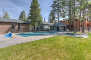 a backyard with a swimming pool and a house at Powder Village Unit D8 in Sunriver