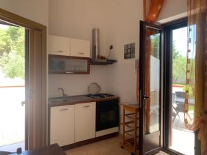 a kitchen with a sink and a stove at Perla del Salento in Otranto